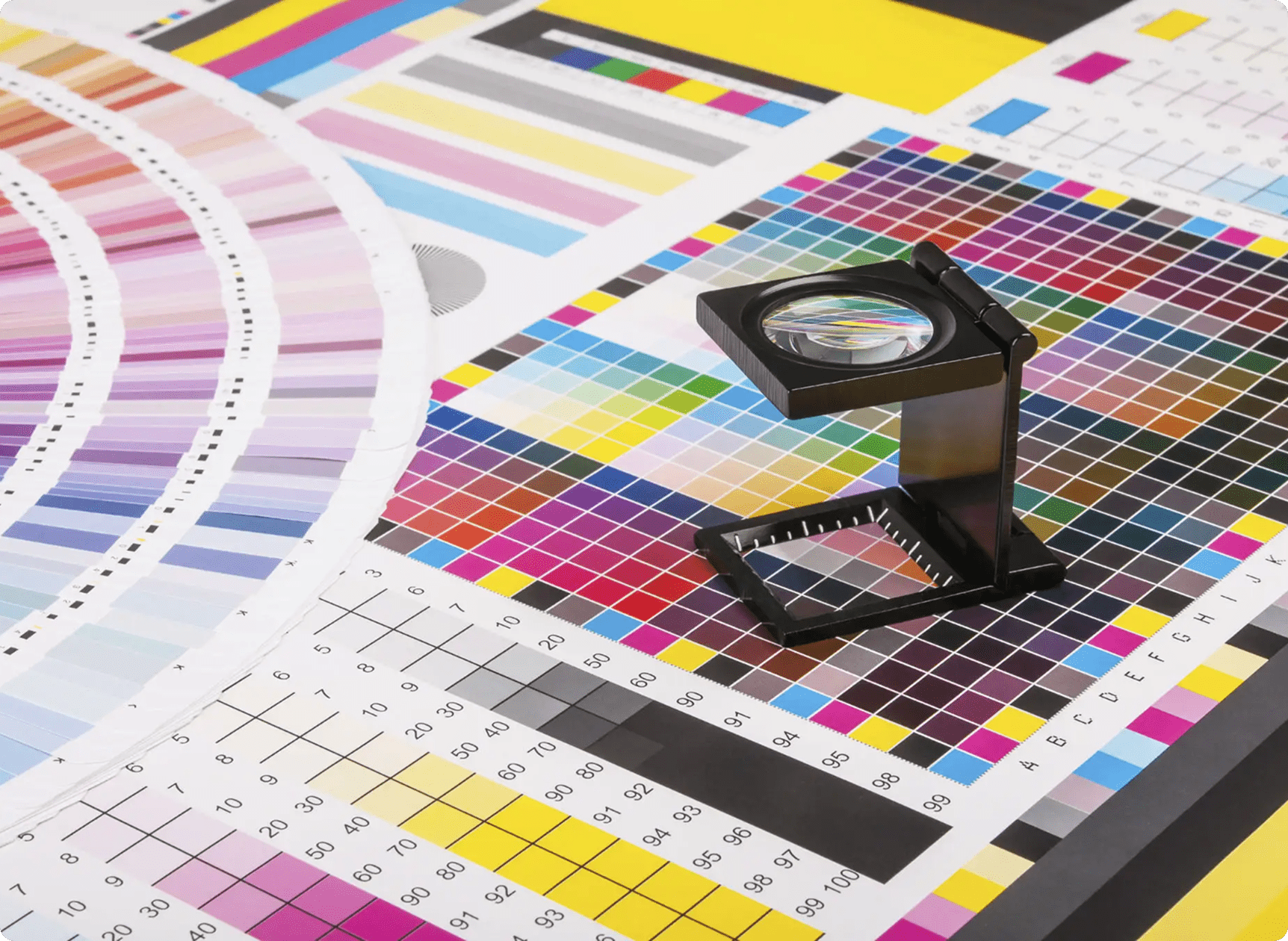 Color chart with magnifying glass on paper.
